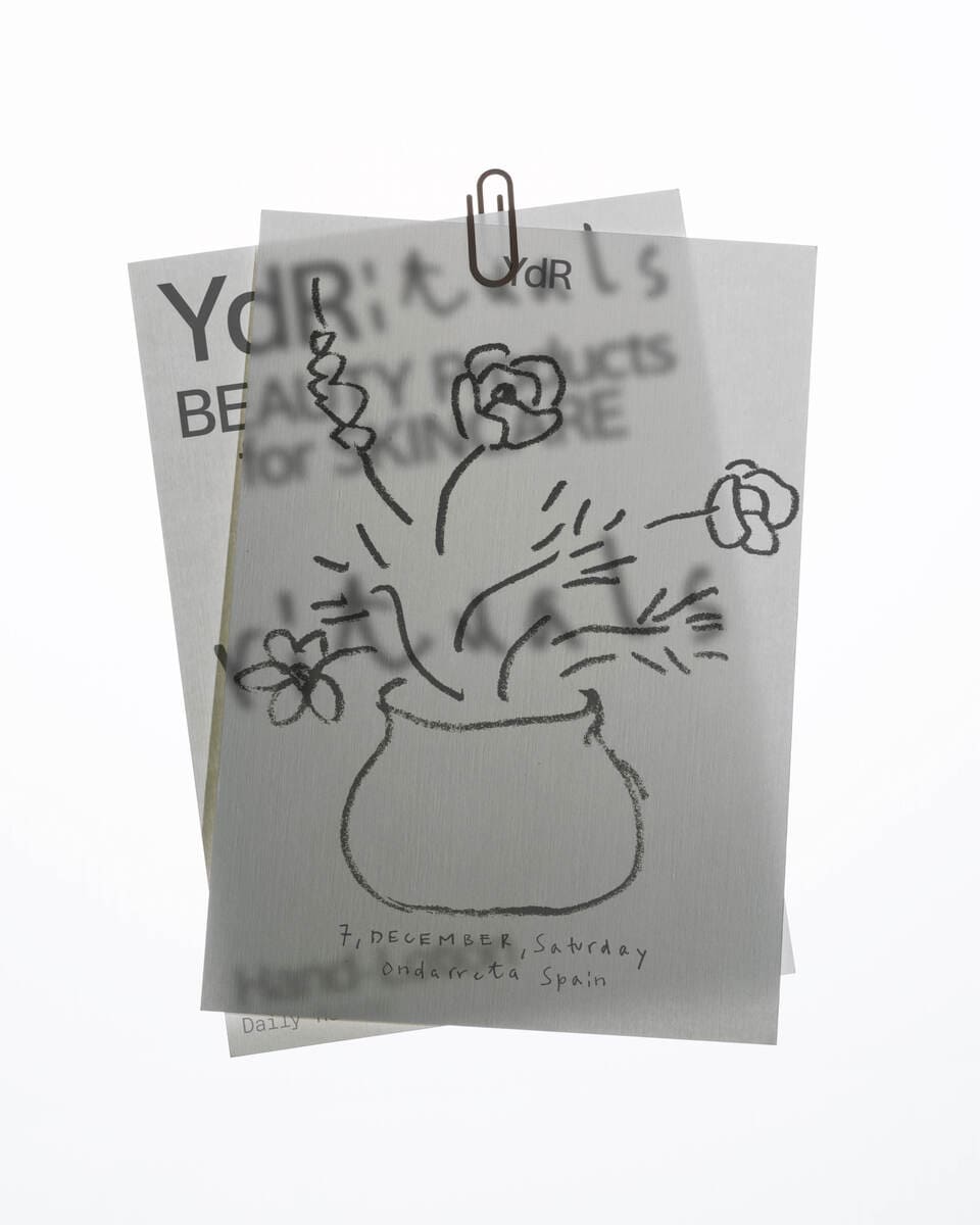 Photo of ilustrations in little pieces of paper with a light as a background that allow to see the paper behind thanks to the paper transparency. 