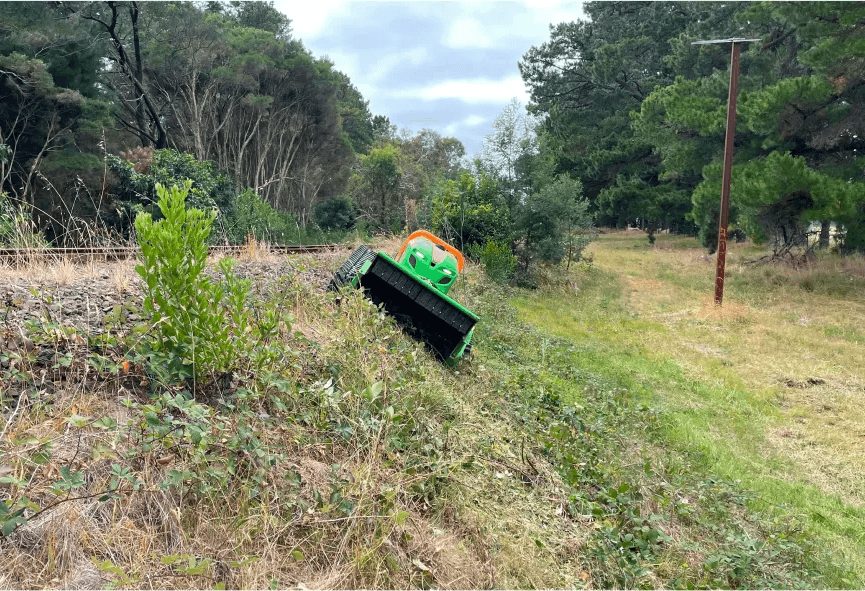 Green Climber mowing on a precarious angle