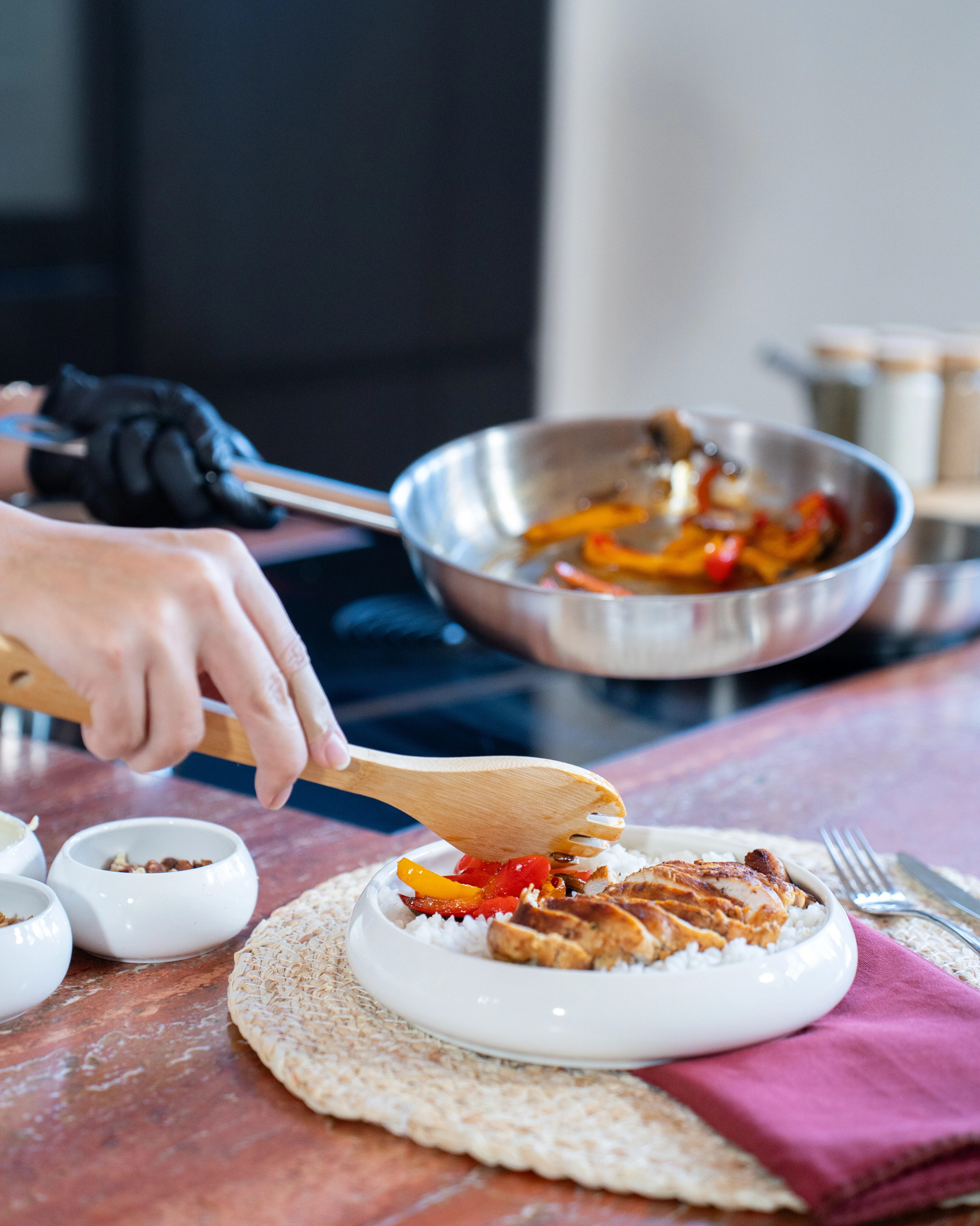 OYM olive oil in a cup with tomatoes and other vegetables on the side