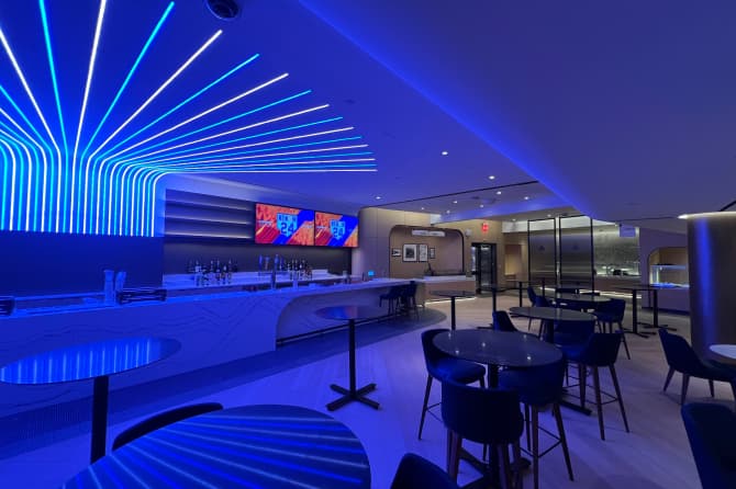 A blue neon bar with modern seating