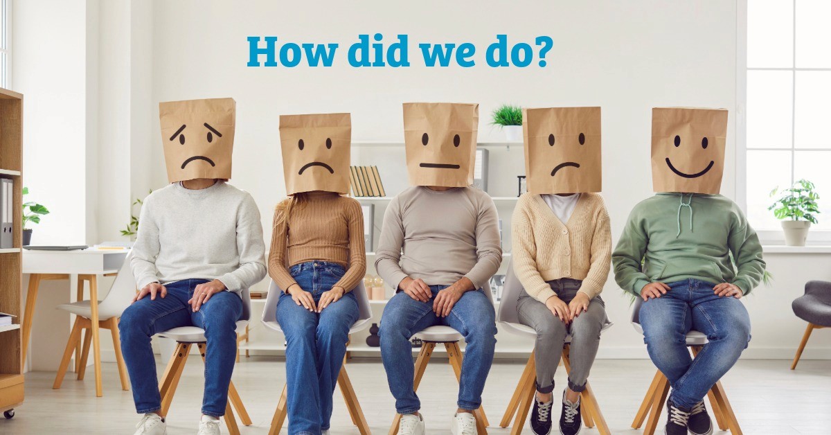 group of men and women sitting in a line with bags over their heads being asked How did we Do?