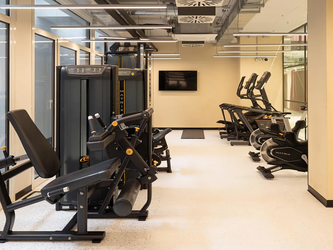 On-site gym with resistance machines, treadmills and cardio equipment at student accommodation in Bologna