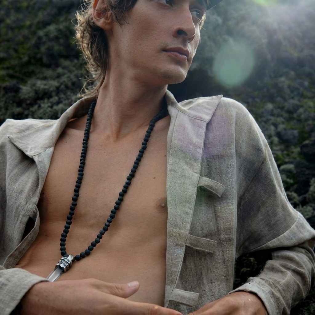 Male model showcasing Five and Diamond accessories with a grey blazer and black necklace