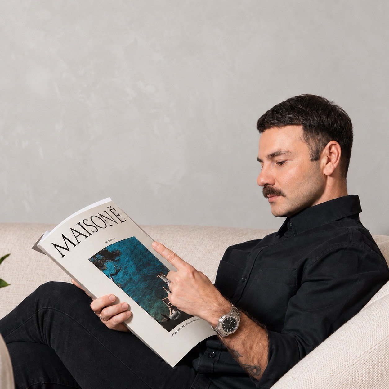 Taskin "Tash" Yüksel reading a magazine