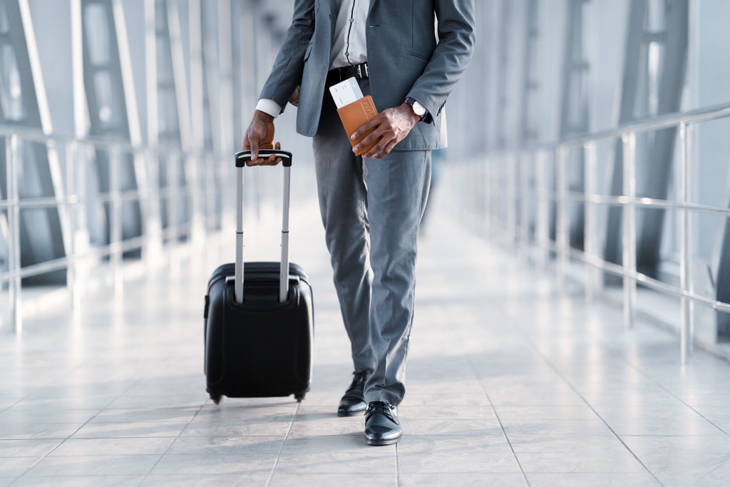 Traveller with a suitcase and passport at an airport