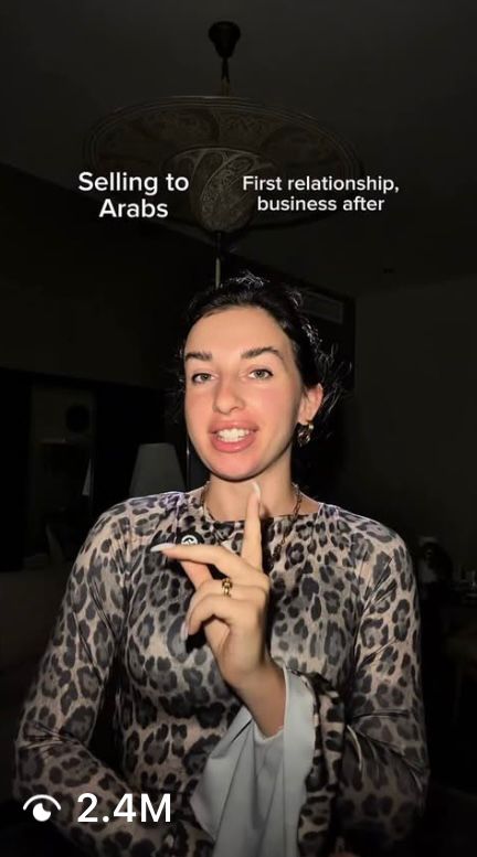 black DSLR camera floating over man's hand at the woods