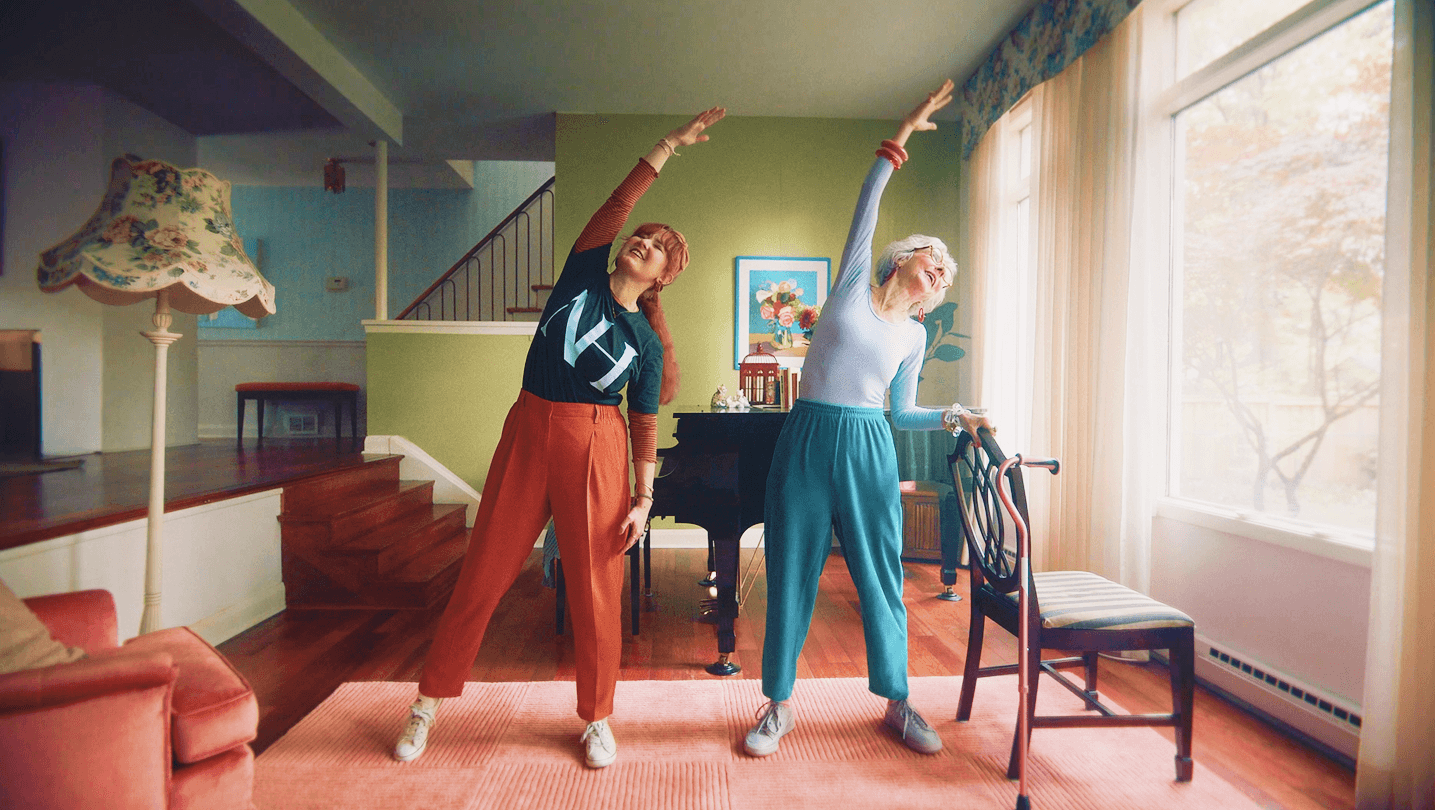 new horizons advertisment with a caretaker doing streches with elderly woman