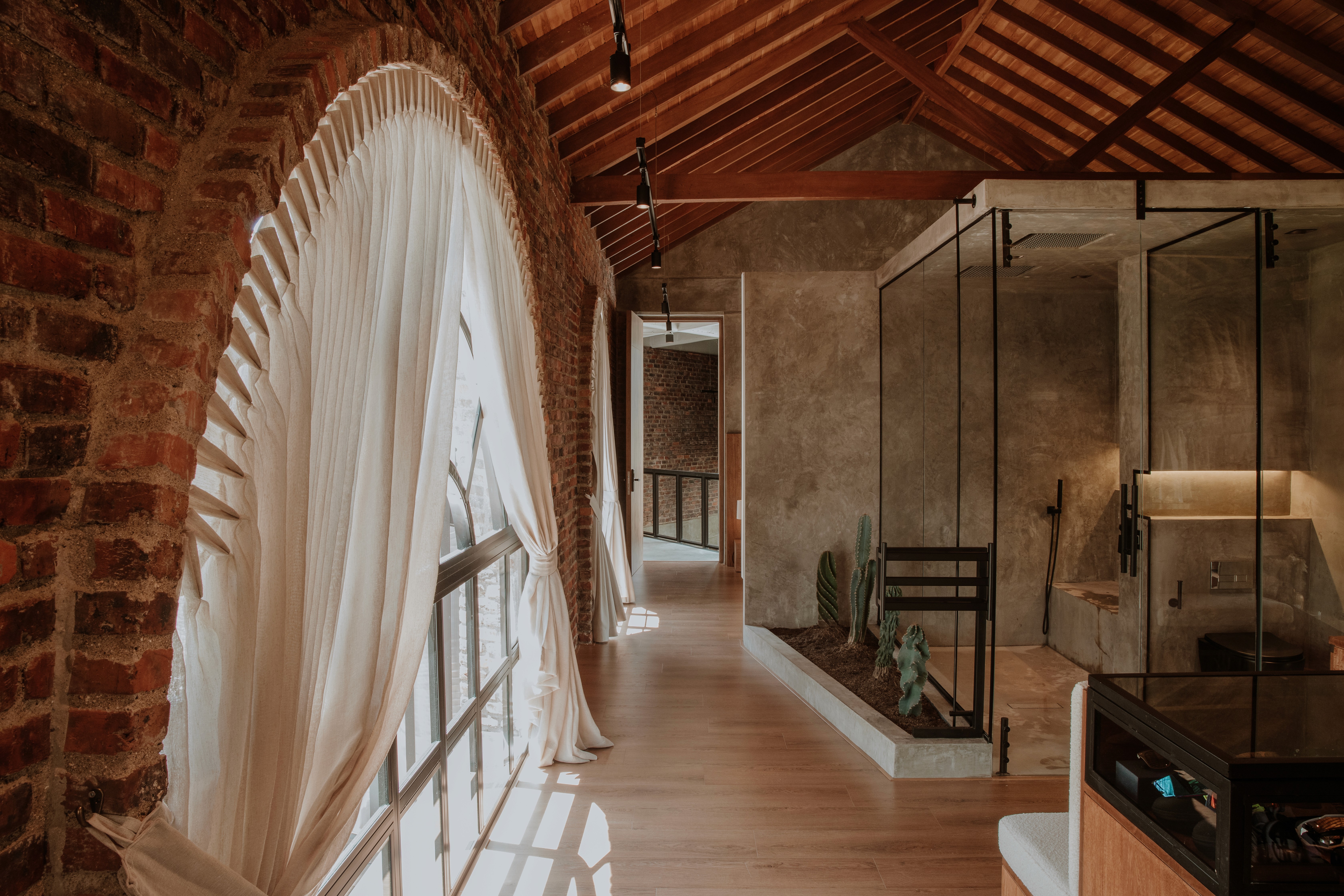 Double-height interior with flowing sculptural forms and warm raking light