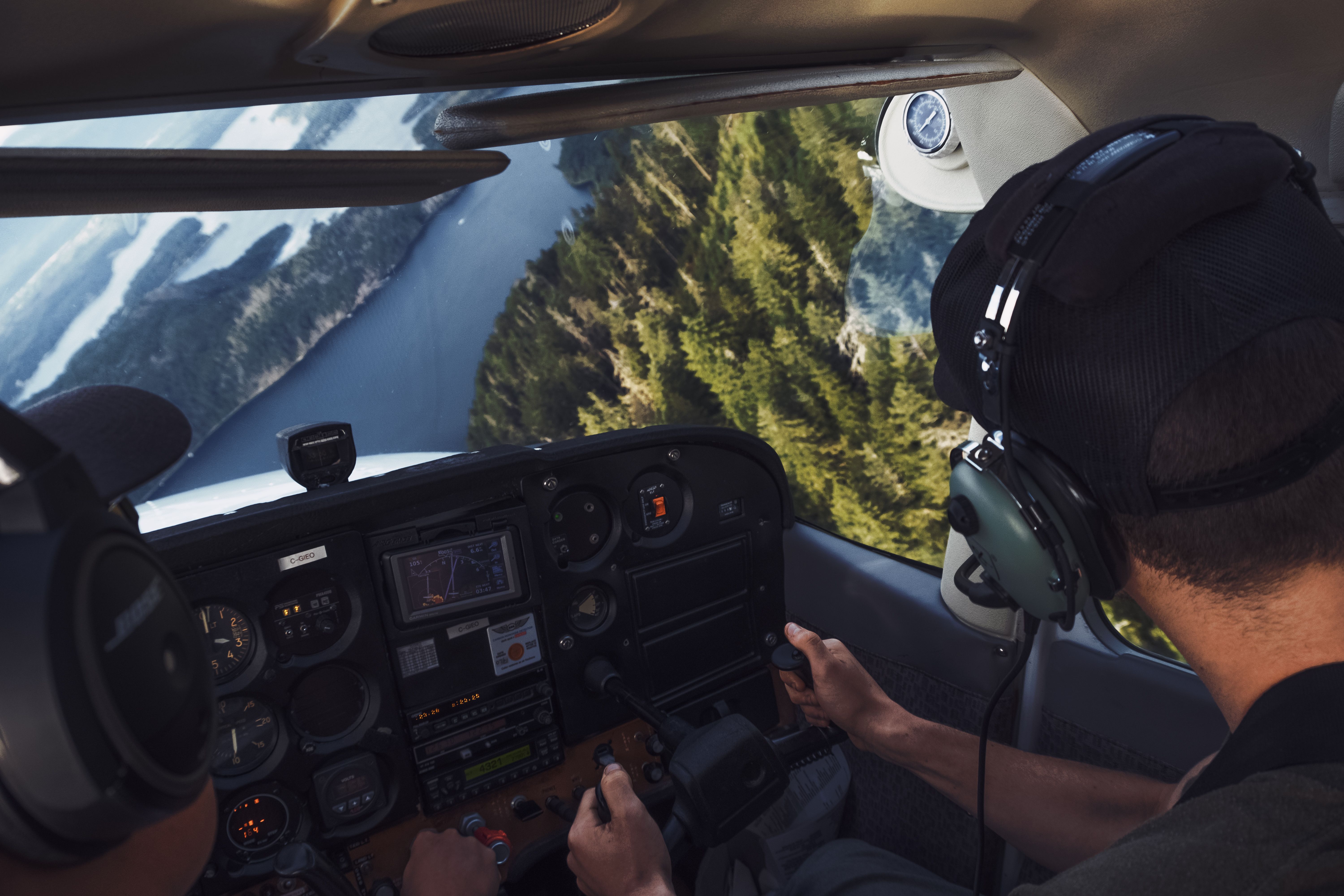 two-pilots-flying-over-a-scenic-river-landscape,-viewed-from-a-cockpit. - rhys-abel (pexels)
