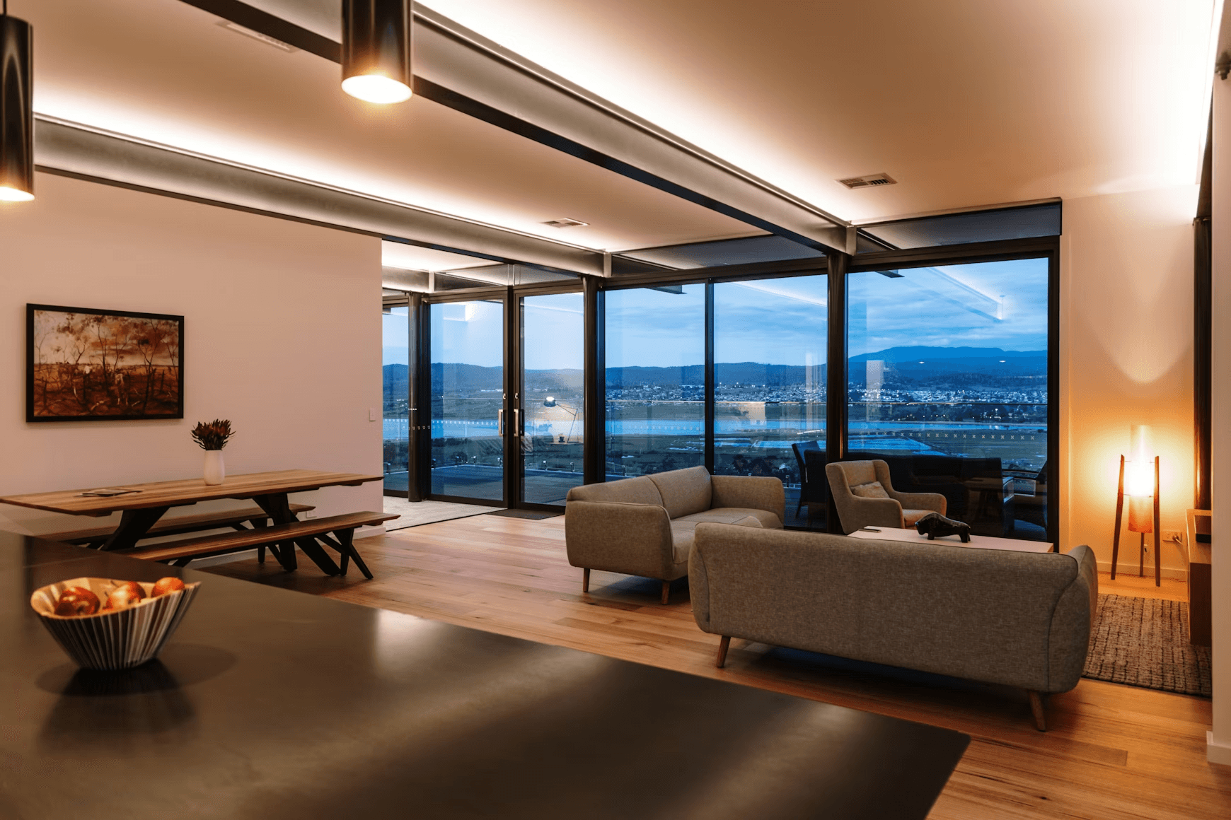 Modern living room with large windows overlooking city lights
