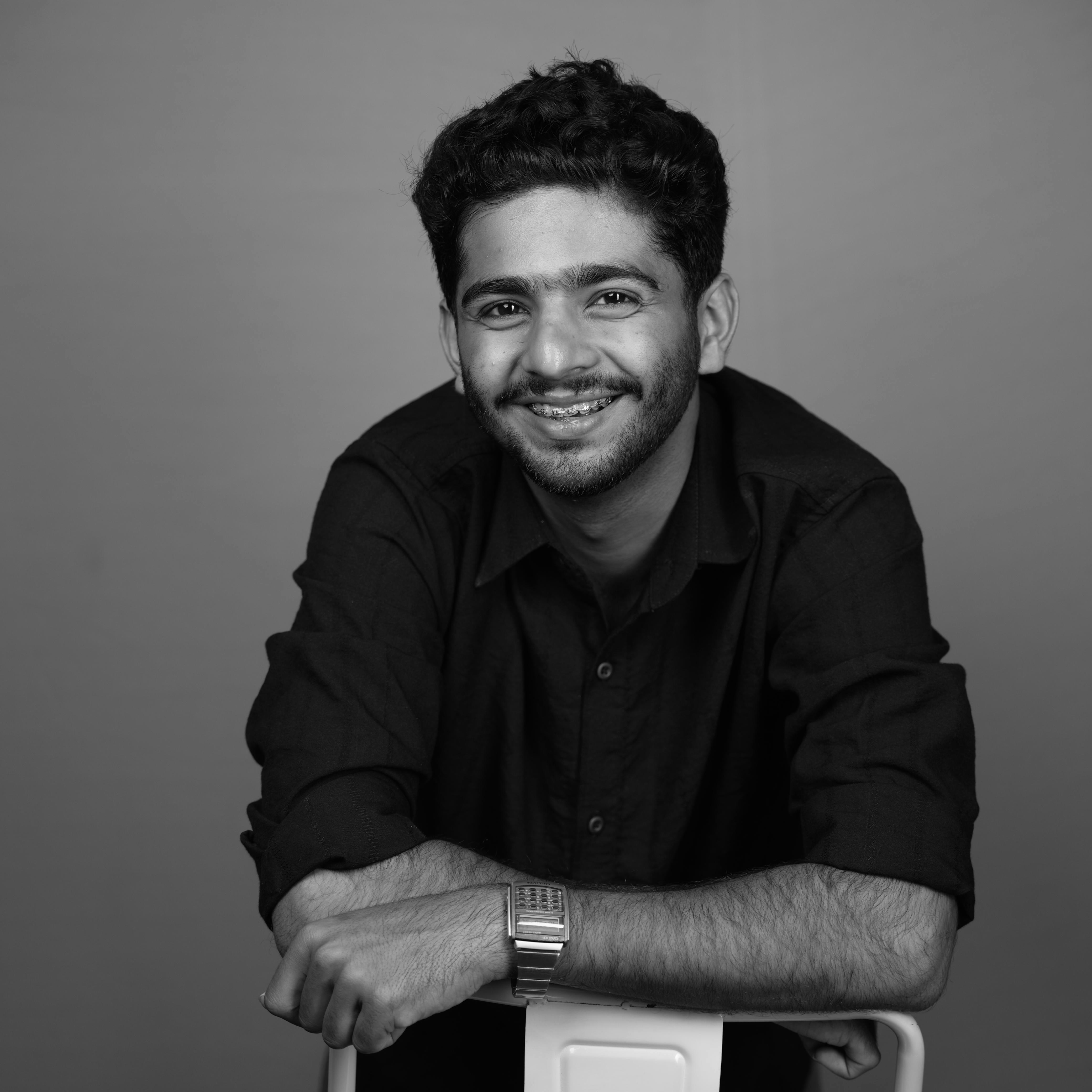 A man sitting on top of a white chair