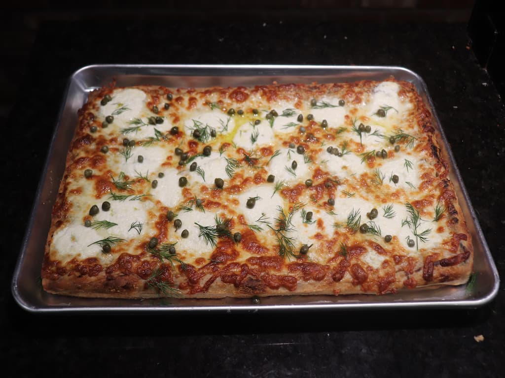 a pizza with tomatoes and onions