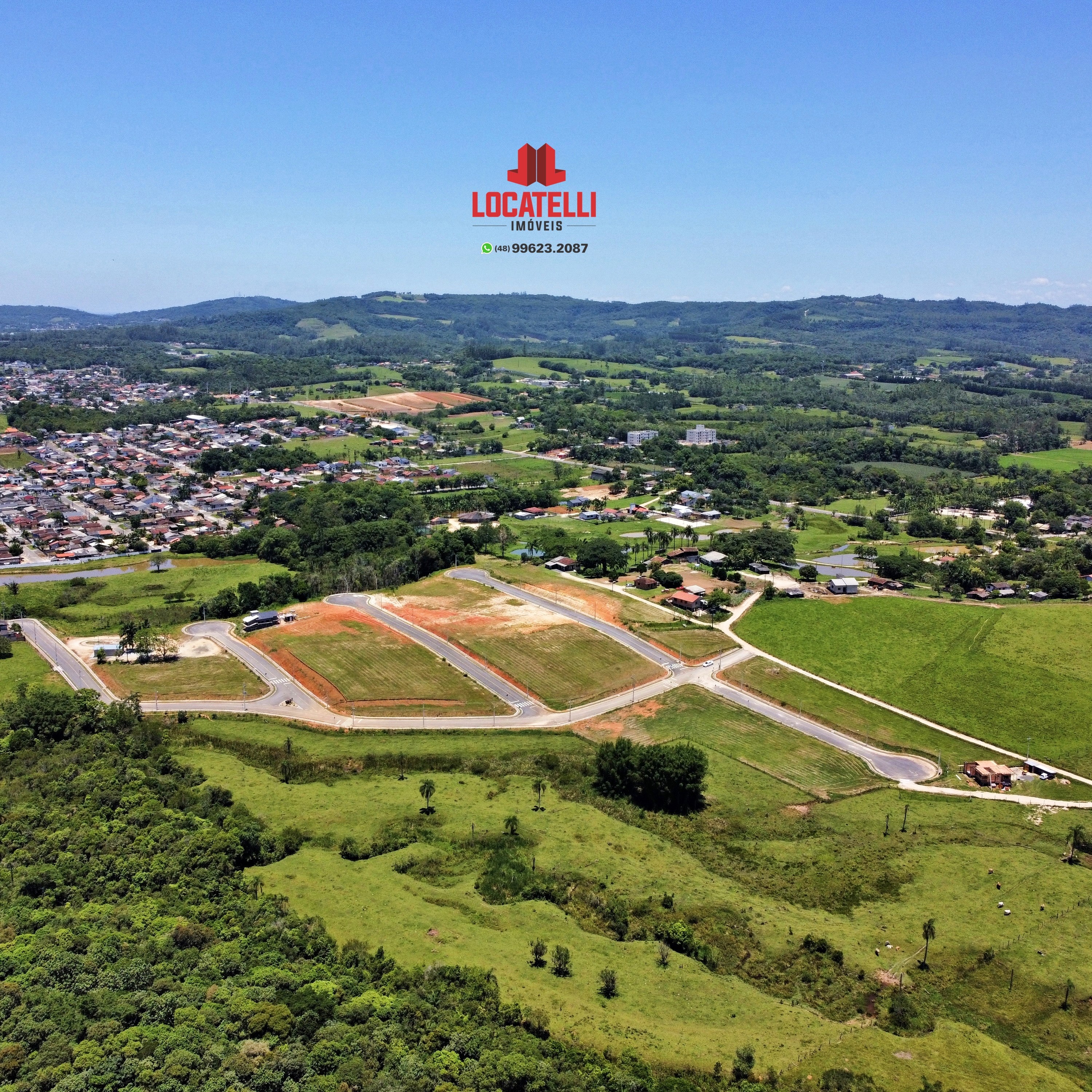A modern brick house with a two-car garage, well-manicured lawn, and clear blue sky in the background.