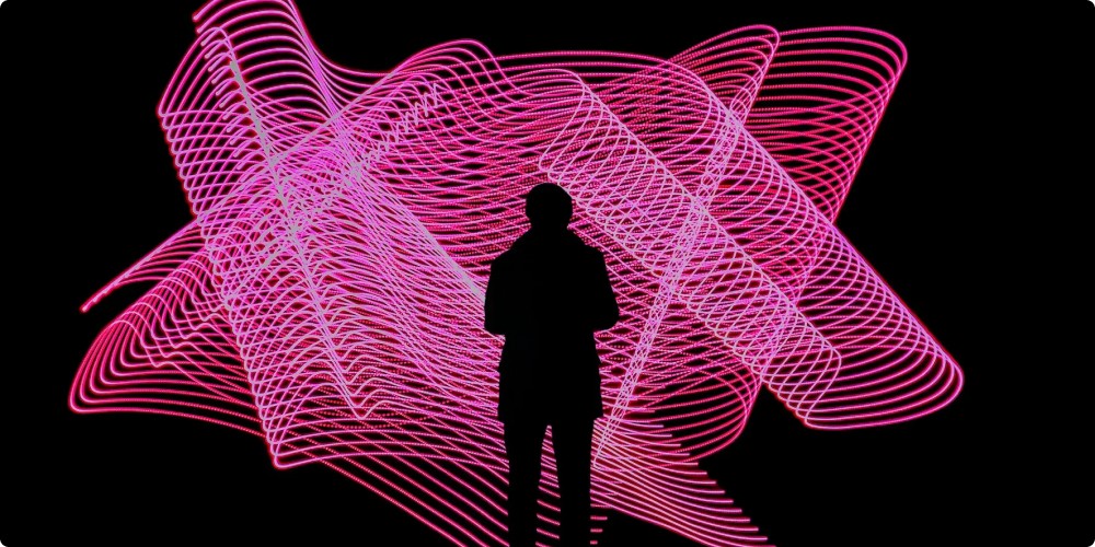 abstract image of a silhouette in front of pink digitised mesh