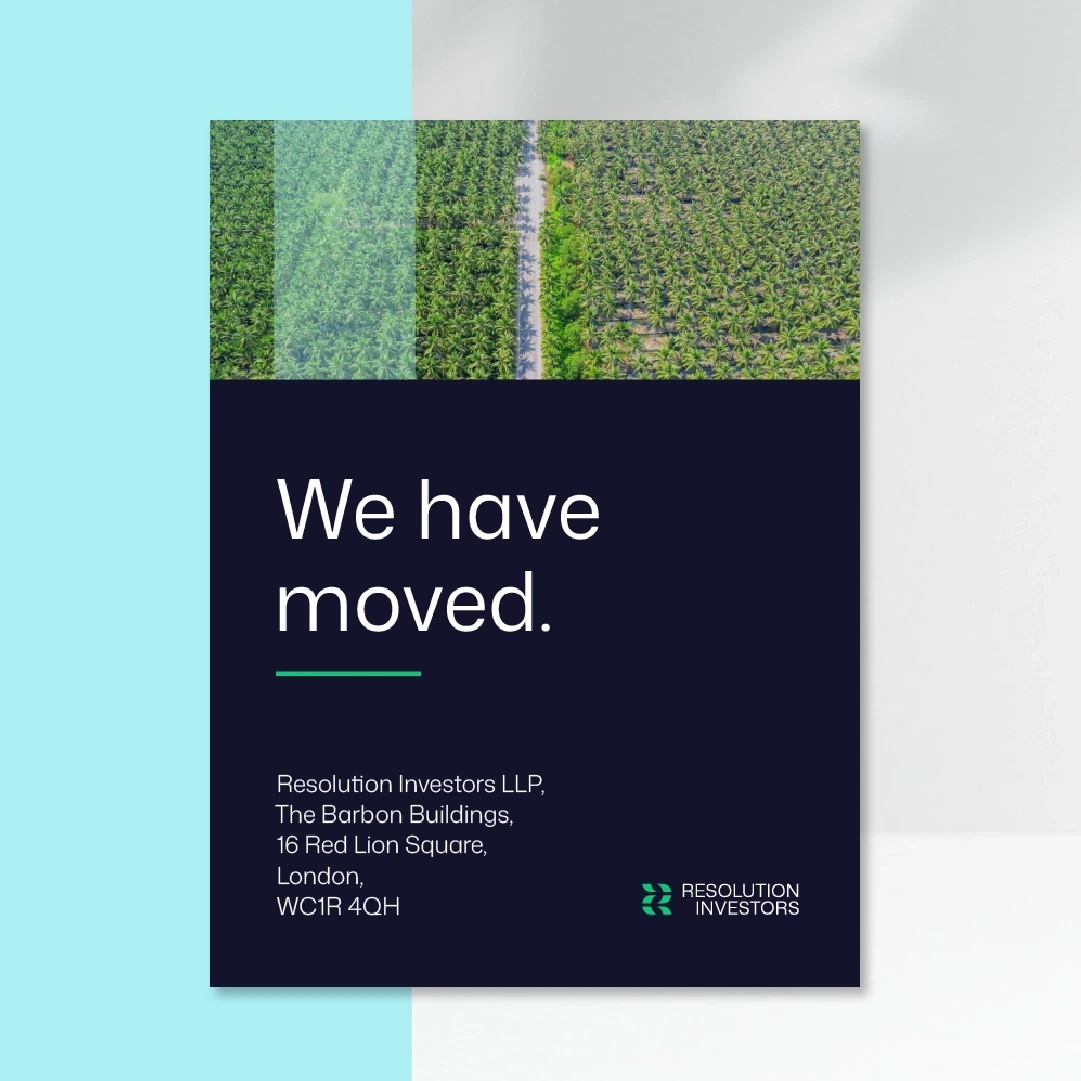 A small bird perched atop a snow-covered evergreen tree.