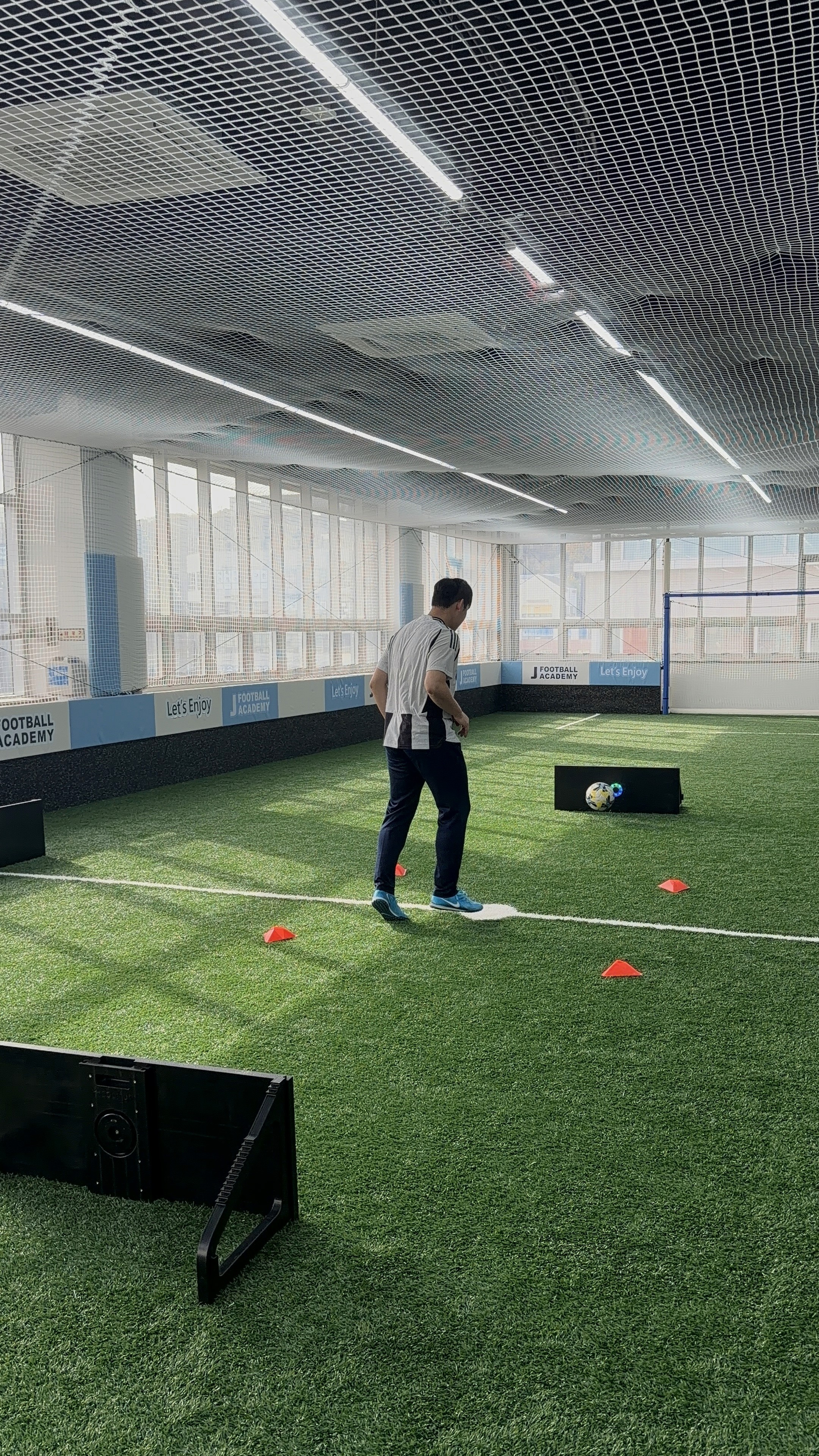 a person's feet with a ball on a purple carpet
