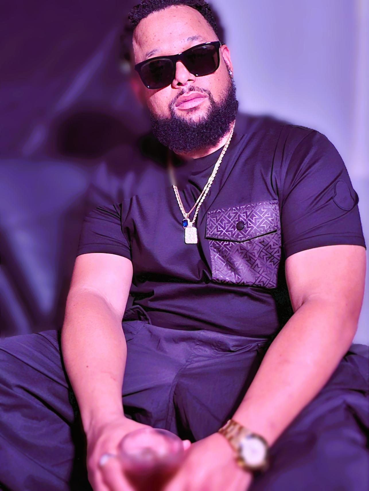 Man wearing sunglasses and headscarf in low light