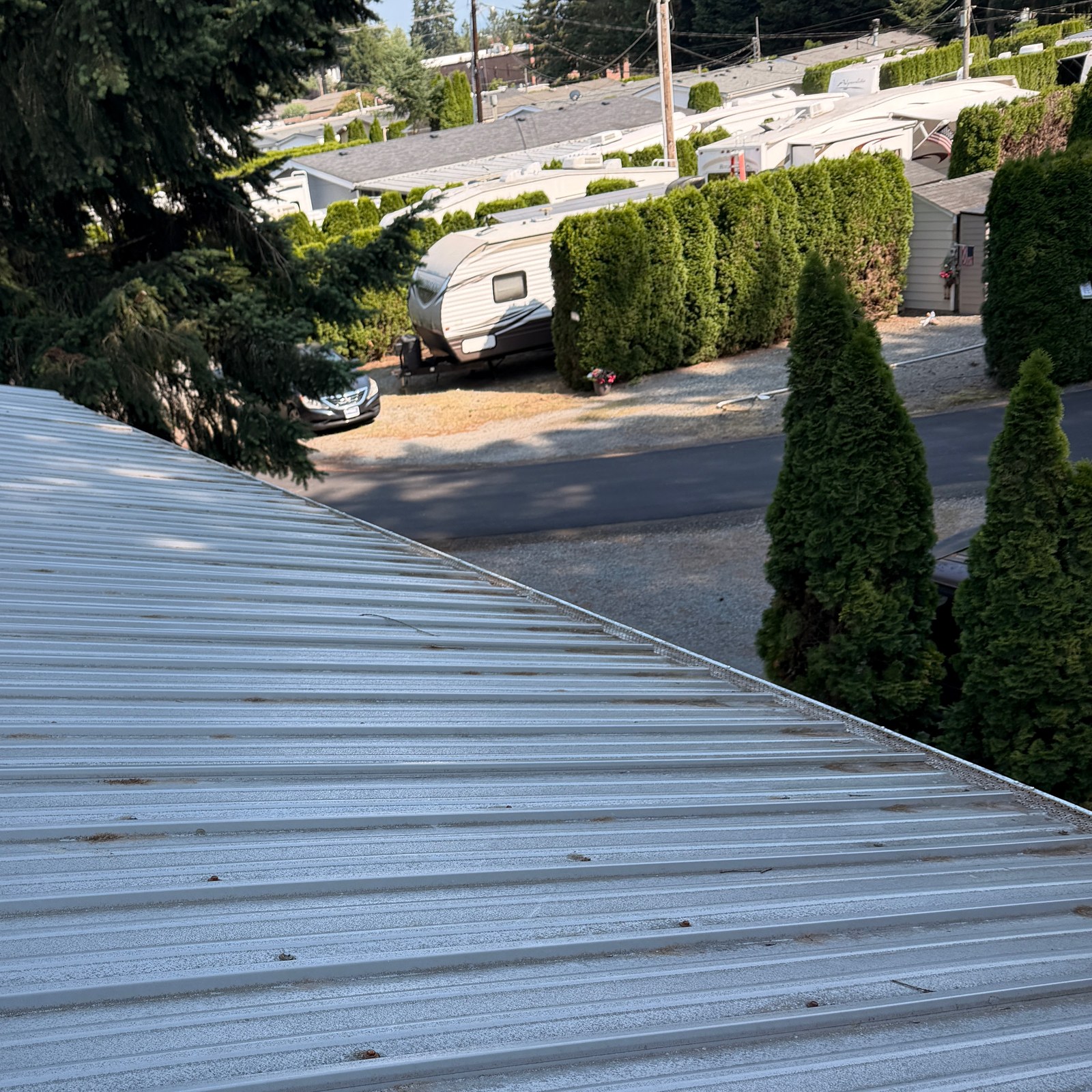After: metal roof blow off and top of gutter screen cleaning by Peterson Property Services in Arlington, WA