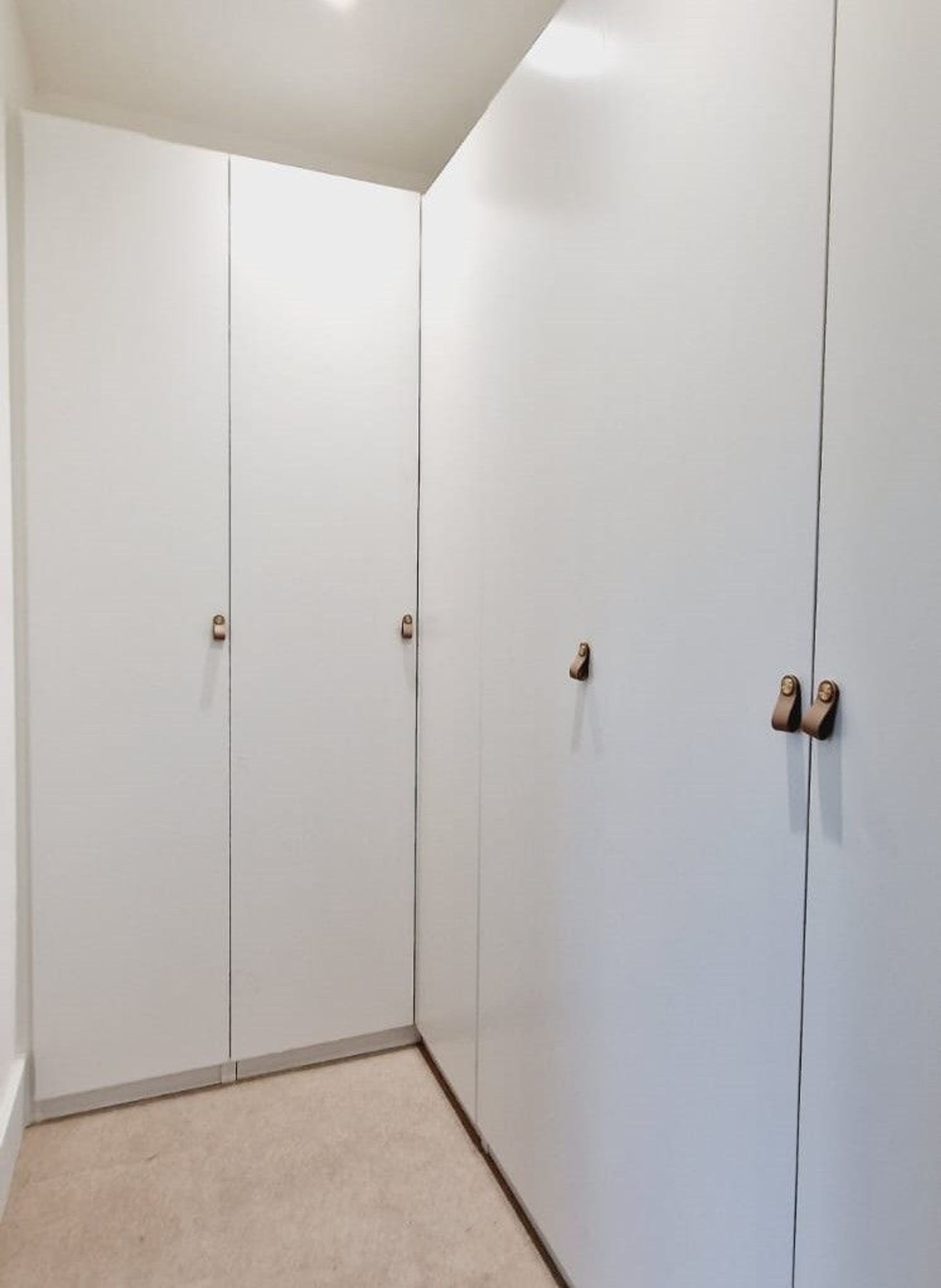 a white corner wardrobe