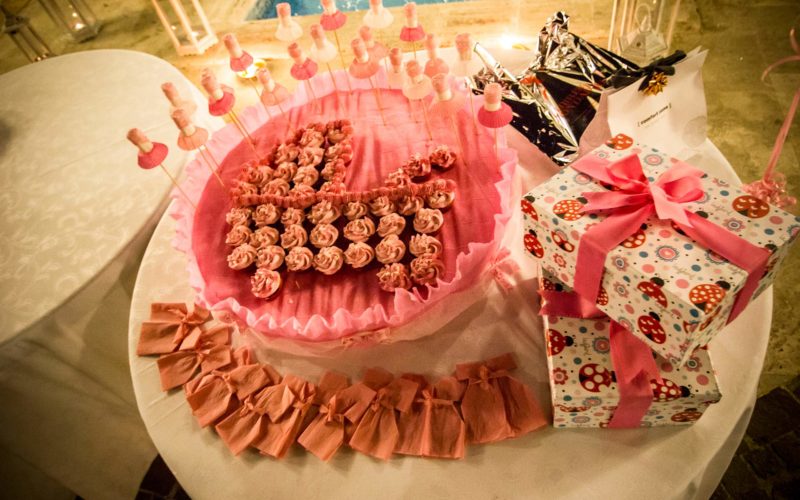 people walking on green grass field near green trees under blue sky during daytime