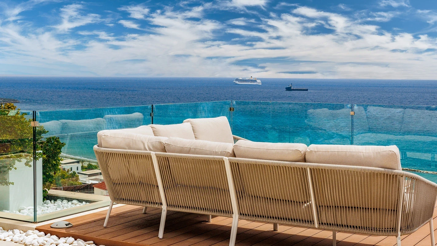Seafront Residence Limassol oceanfront terrace lounge with sculptural sofa and infinity-horizon backdrop