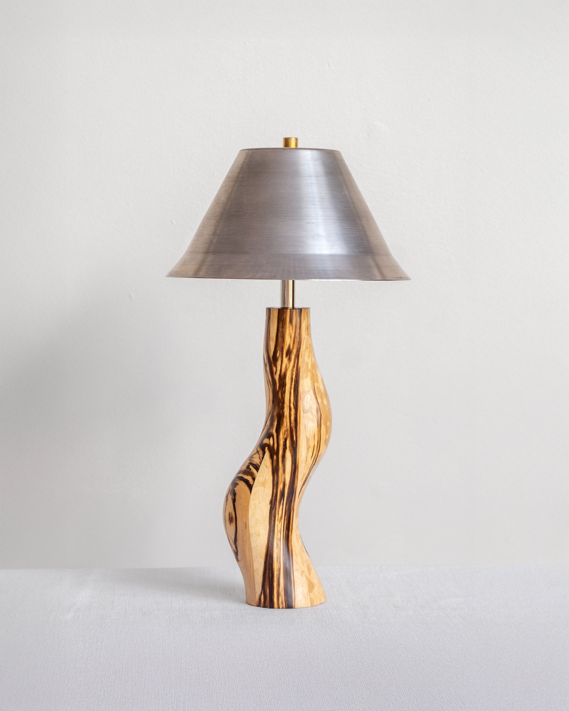 Dancing Desk Lamp with Spalted timber base and Raw Steel shade on a light grey background with UK, EU and US/CA wiring available Wilkinson & Rivera