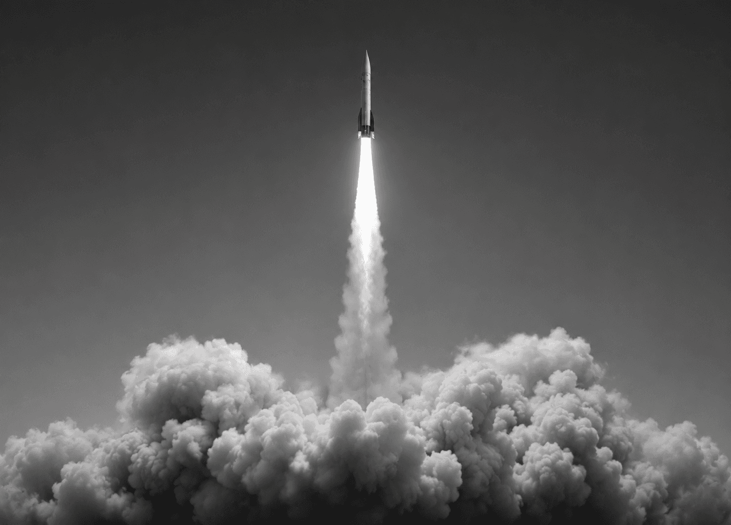 a black and white photo of a plane in the sky