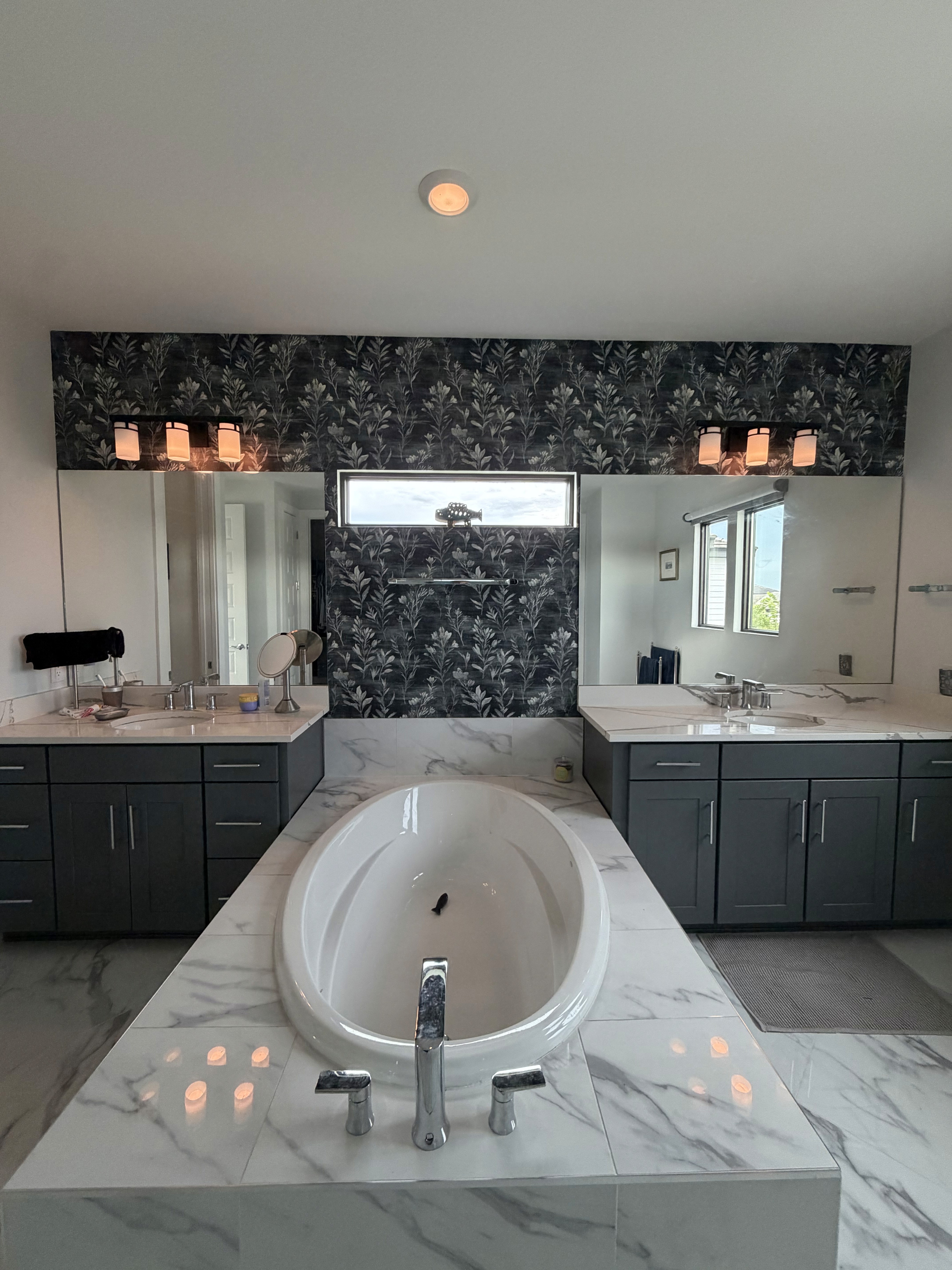 Powder bathroom wallpaper installation with patterned luxury wallcovering