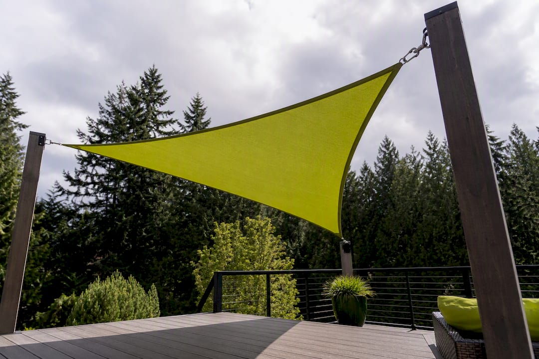 Triangular shade sail over residential deck