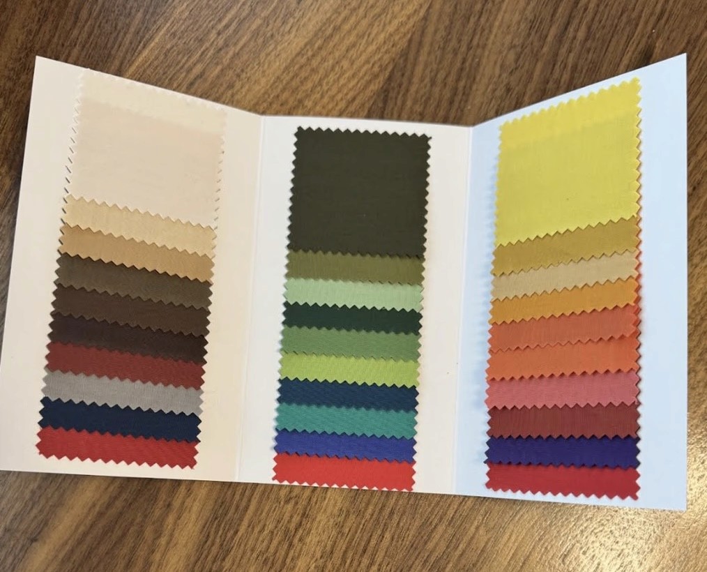 Four seasonal colour fan decks labeled Spring, Summer, Autumn, and Winter, each showing a range of fabric swatches used in personal colour analysis to identify the most flattering tones.