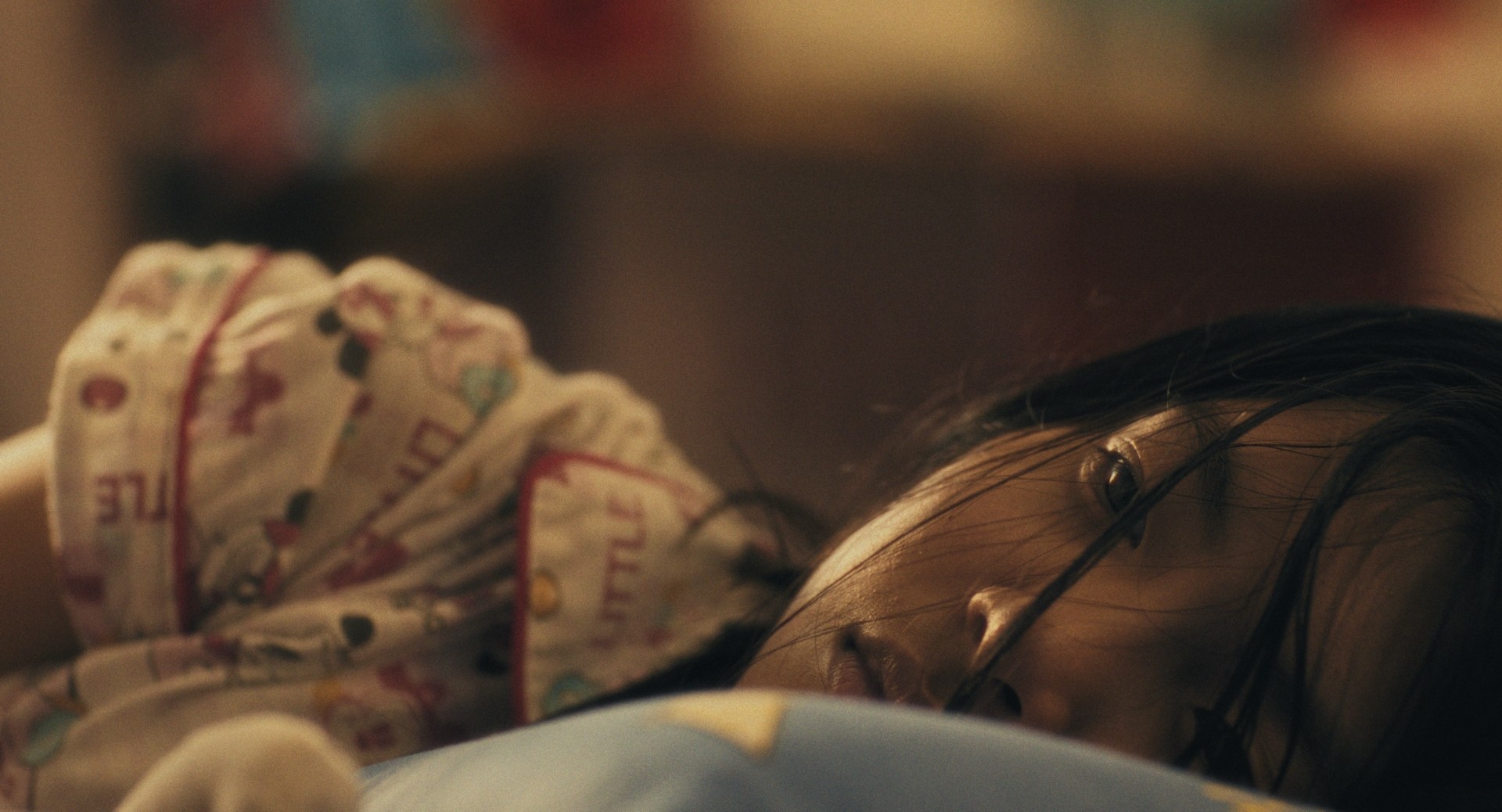 Mirage Still 2: Eliza lies in bed.