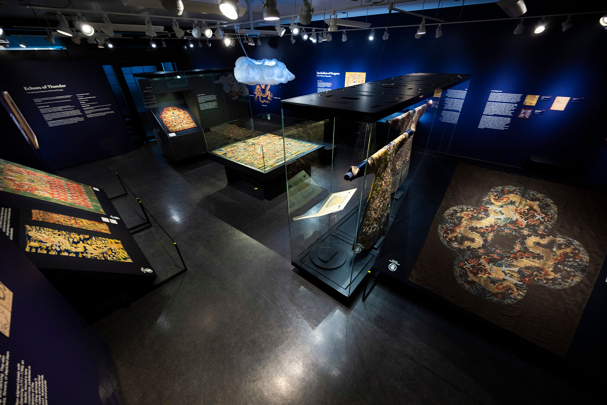 a birds eye view of a museum exhibit displaying ancient chinese textiles