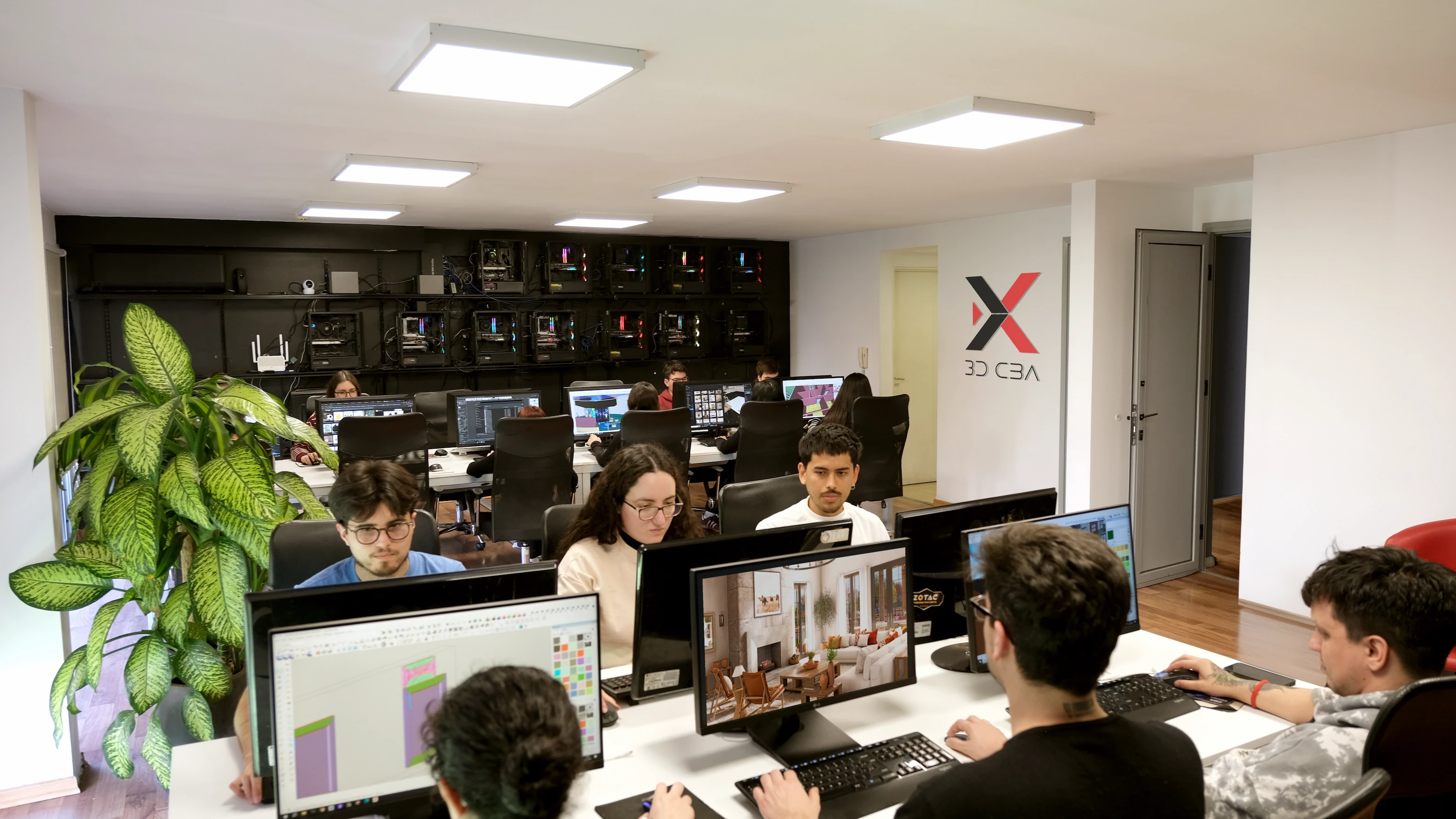 Inside the 3D CBA studio: the team modeling and rendering architectural projects, with the company logo on the wall and design previews on the monitors.