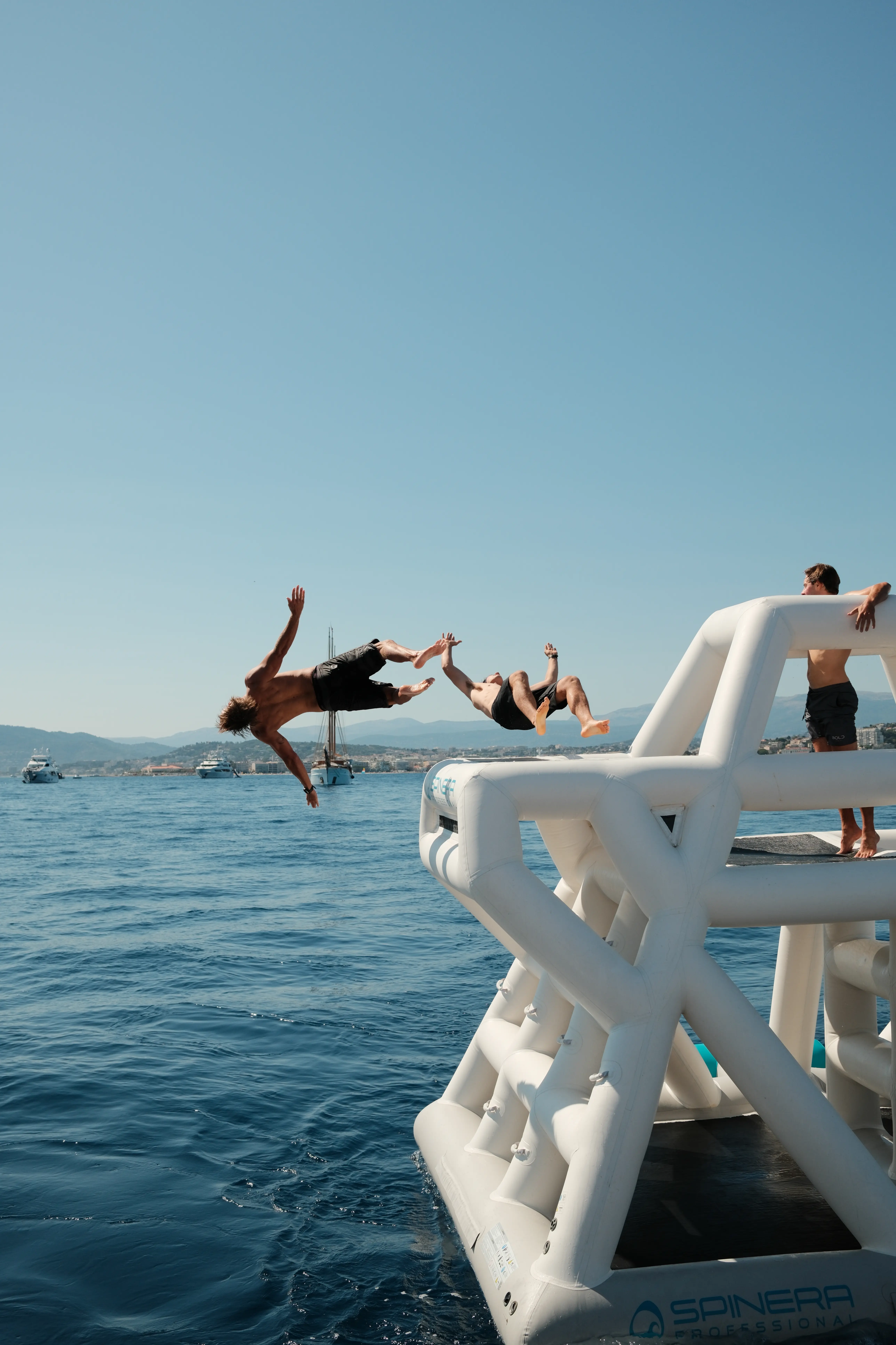 Sunlit coastal dining room with rustic wooden table.