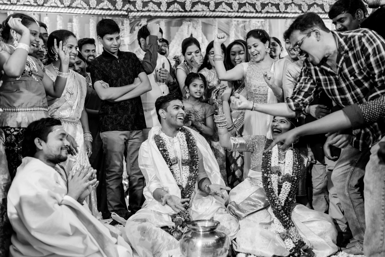 Harshitha and Jashwanth enjoy a playful ring-finding game. Black & white Fine Art Wedding Photography in Hyderabad by Out of The Blues.