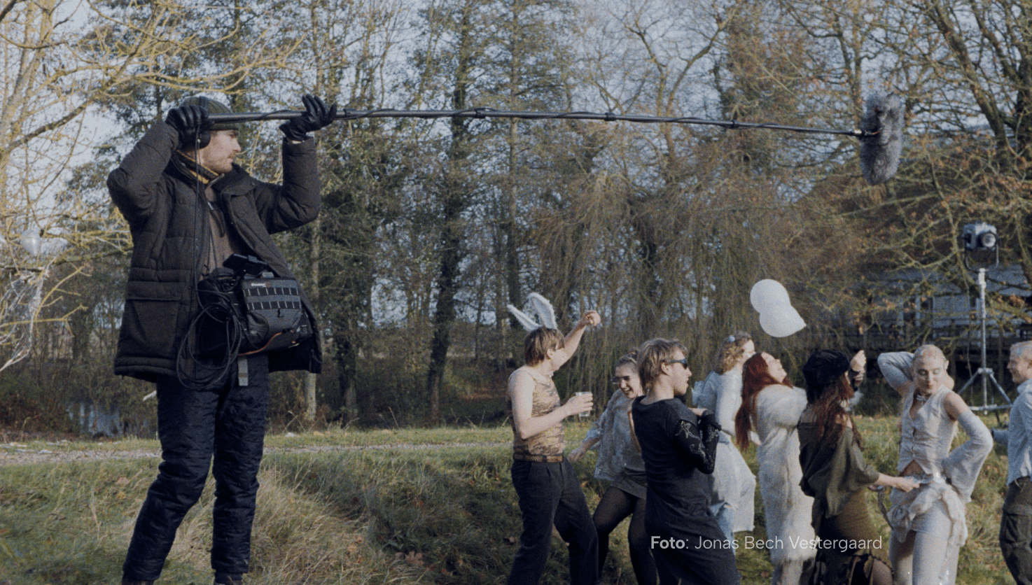 People on a film set in nature.