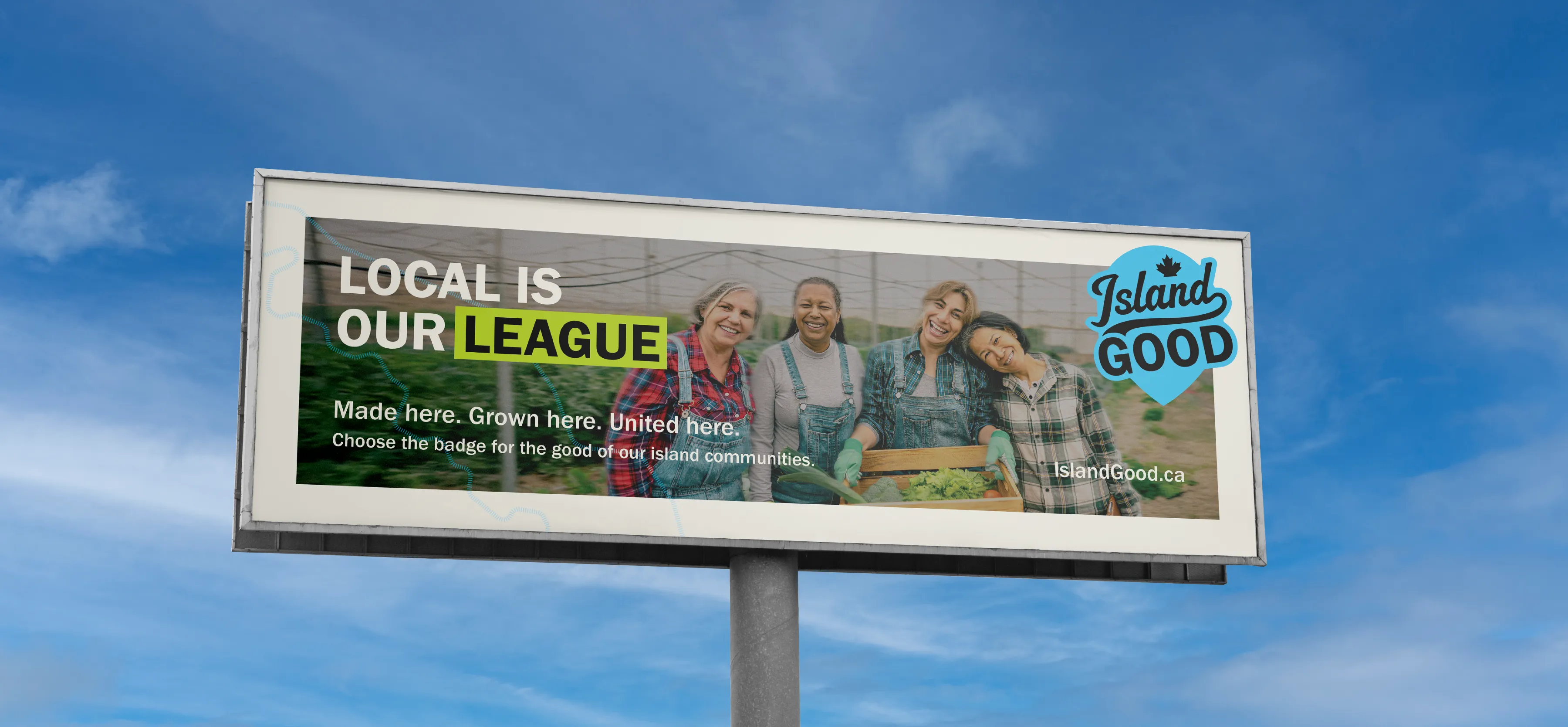 An Island Good Billboard that says "Local is Our League" with League highlighted with a green box. The Island Good logo is in the top right corner in blue and the background is an image of 4 women huddled up smiling in a green house.