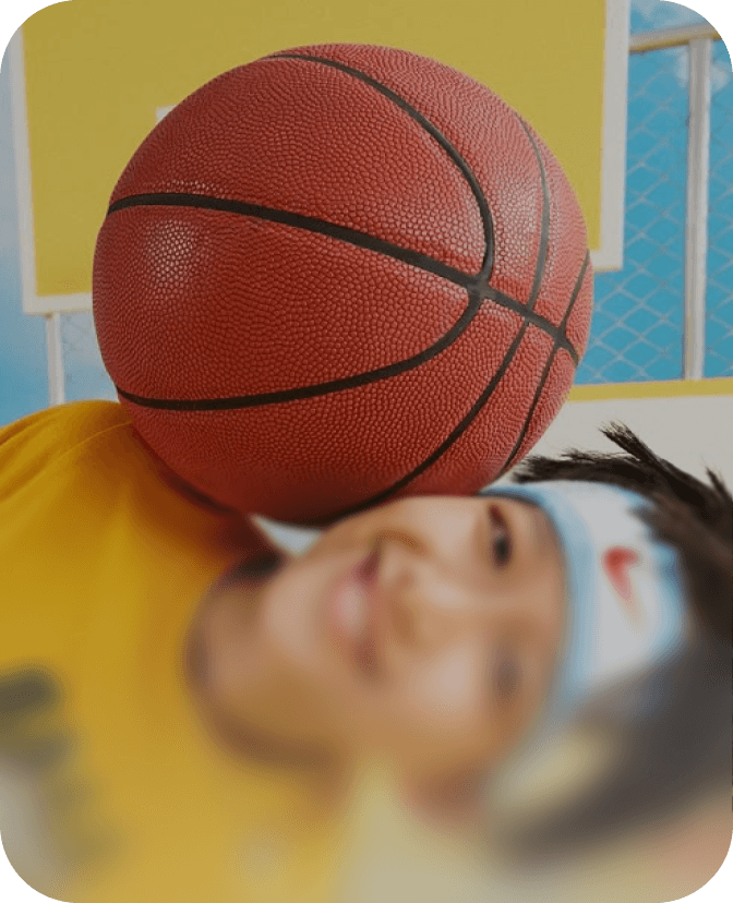 Small boy playing basketball and smiling