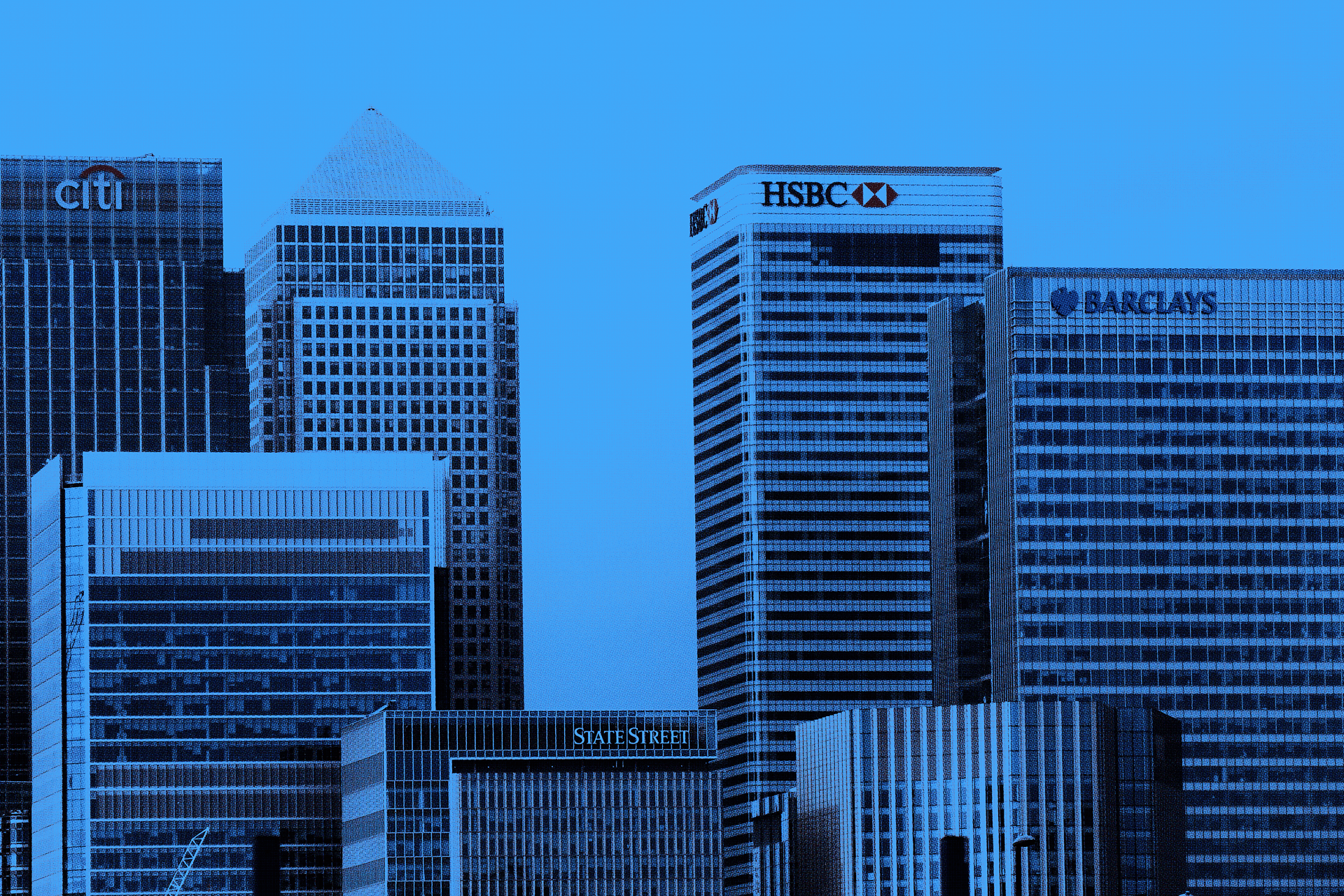 Close-up of a scientist holding a tray of petri dishes with purple cultures, wearing gloves and safety gear.