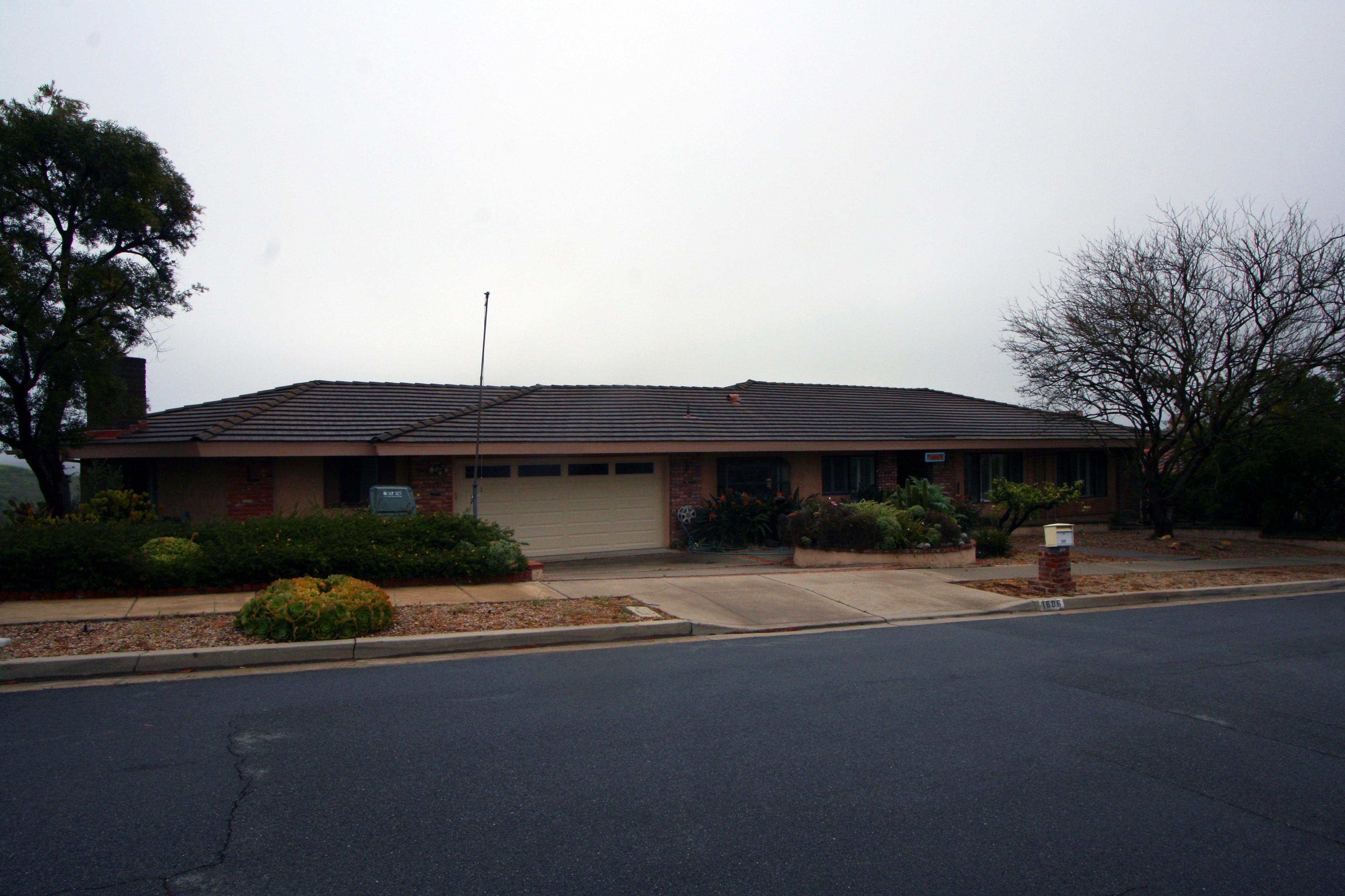 Before photo of an old ranch-style home exterior.