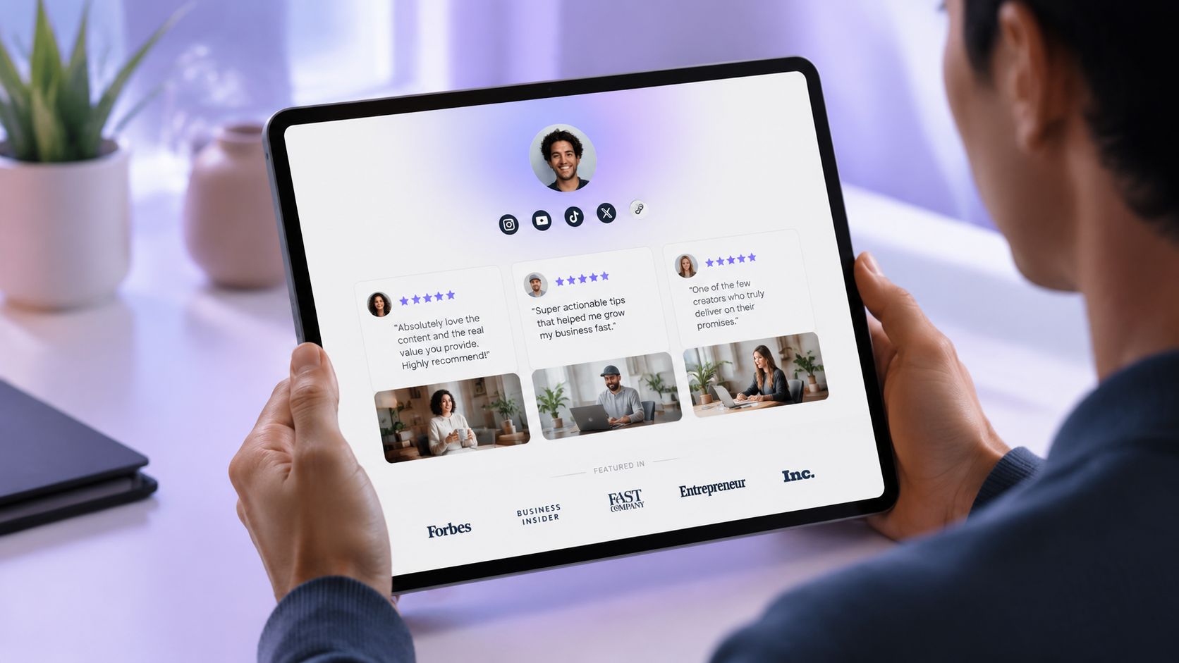 A person holding a tablet showing a professional profile page with testimonials and social media links.