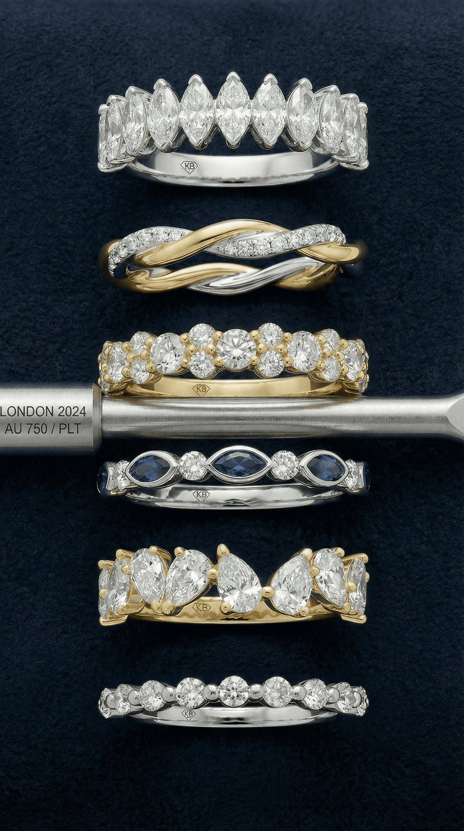 Wedding band stack on navy suede with hallmark and jeweller marking tool