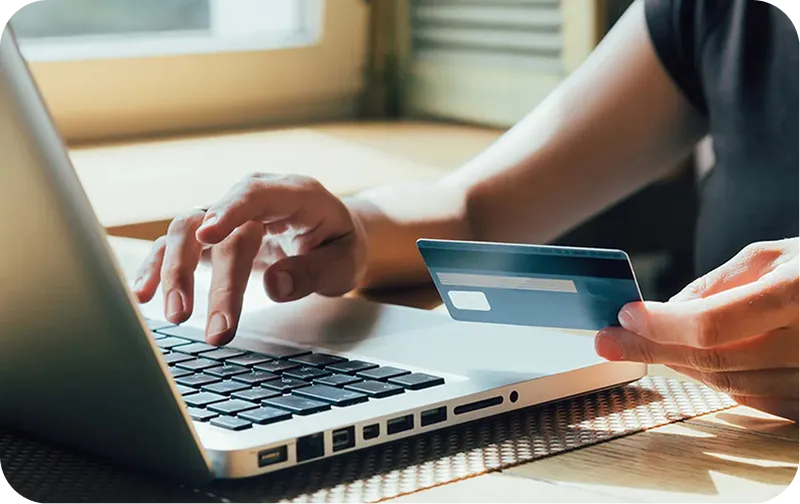 Customer paying online with a card and laptop