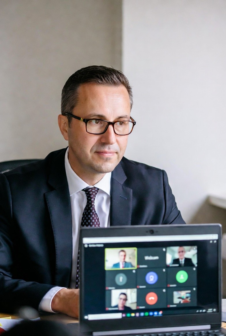 a man with a goatee smiles at the camera