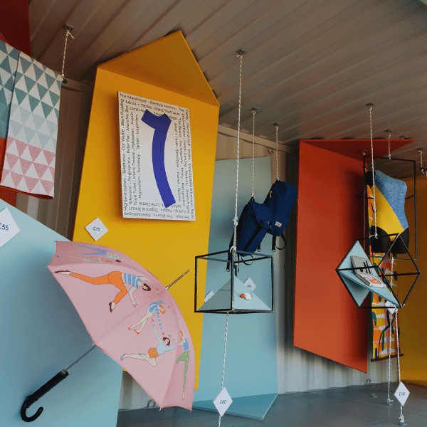 Pop up exhibition design in a converted shipping container, including a CNC cut sign as part of the sculptural installation