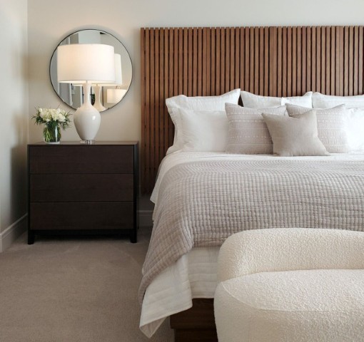 Image of Luxurious primary suite with plush bedding, modern furniture, and elegant interior design by KHD Homes.