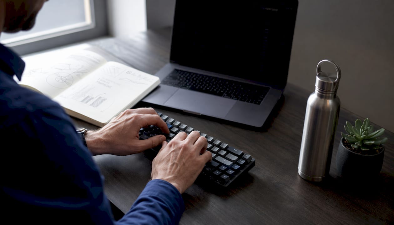Overhead of hands working at analytics desk