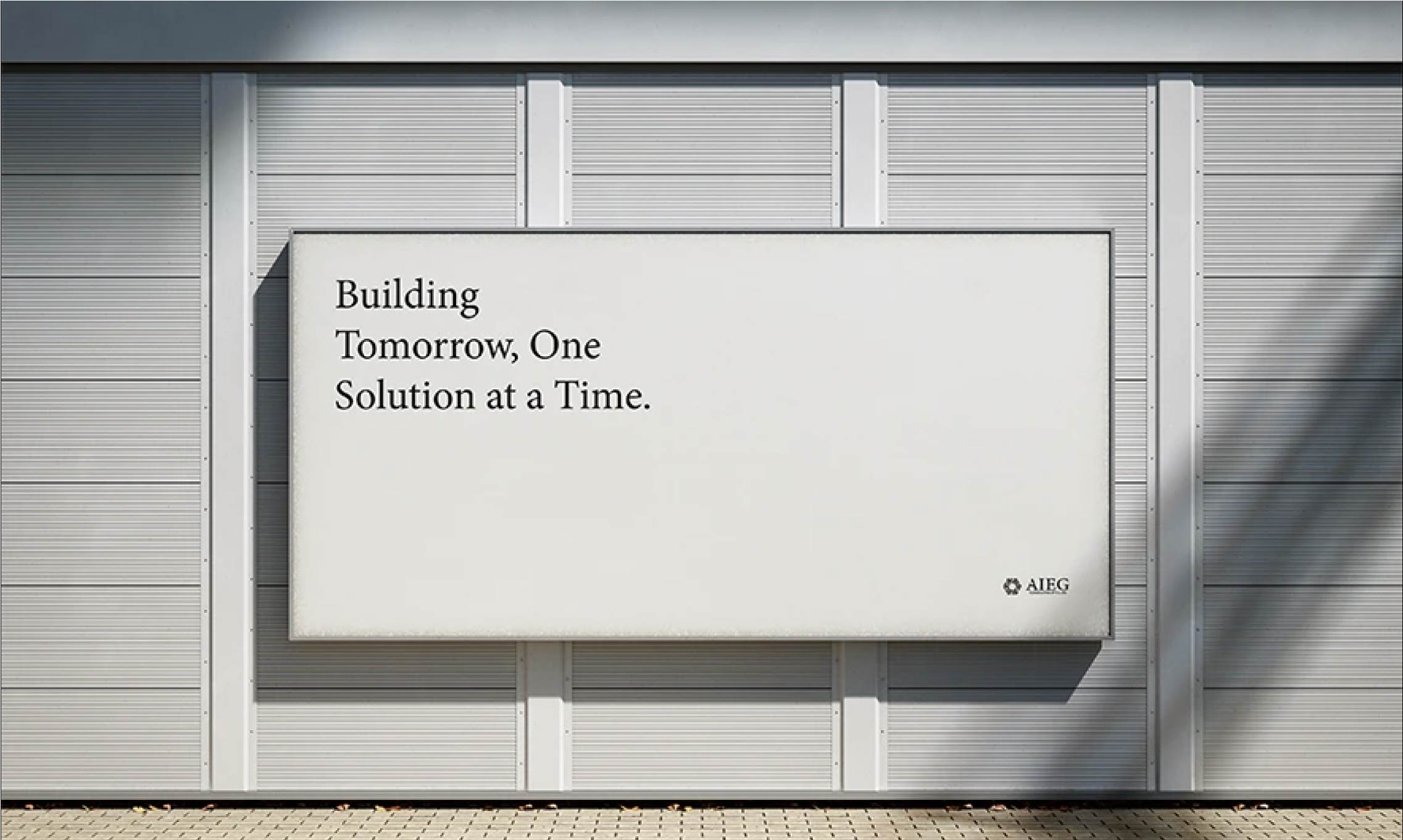 Billboard mockup featuring a white background with black text and the company logo placed in the bottom right corner