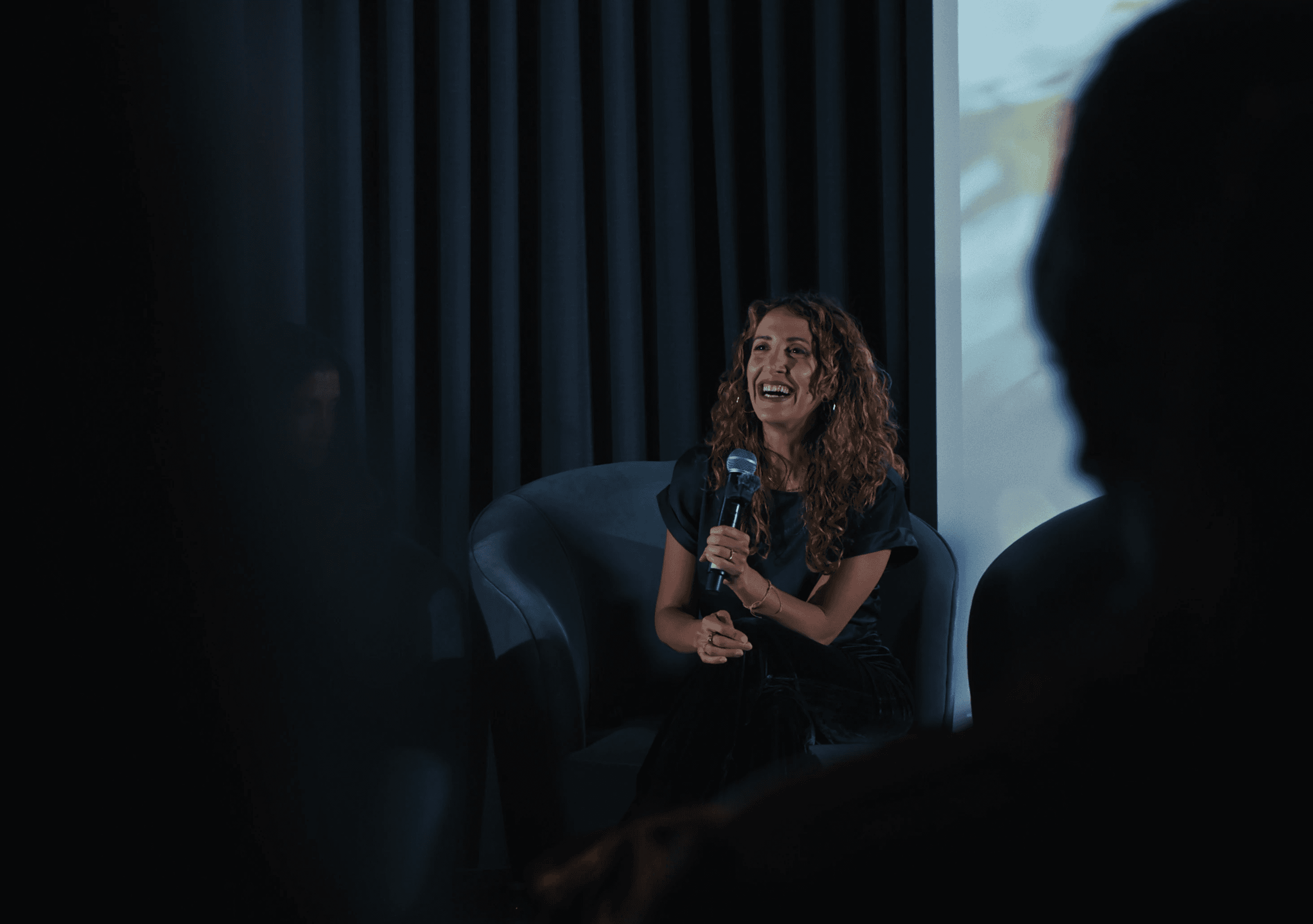 Photo of Creating Producer Patricia Marcoccia smiling while giving talk on a panel