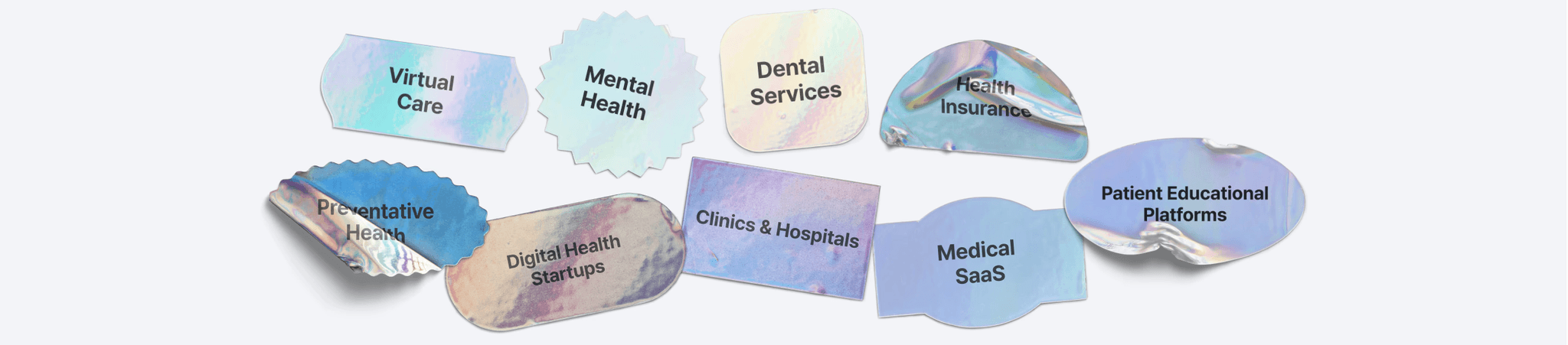 Close-up of two smiling friends with freckles, bright makeup, on a light blue background—joyful, inclusive brand portrait.